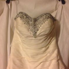 a wedding dress hanging on a hanger