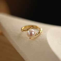 Simply chic, this ring is a clever accessory you'll love to wear. This pearl ring features a unique design inspired by bamboo, adding a touch of natural elegance to your jewelry collection. Combining the allure of pearls with the symbolism of bamboo, this ring represents a harmonious blend of natural elements and artistic craftsmanship. It is a celebration of the delicate balance between strength and beauty, resilience and elegance.Weight: 2.3 gMaterial: 925 SilverPlating Color: Yellow Gold Pearl Bangles Gold Jewelry, Gold Ring Pearl, Pearl Ring Designs Gold, Pearl Rings In Gold, Pearl Ring Designs, Jewellery Lookbook, Pearl Bangles Gold, Pearl Ring Design, Pearl Ring Simple