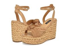 Nine West Eaden 1 - Women's Sandals : Light Natural : Step into summer elegance with Nine West Eaden 1 sandals. Crafted with intricate braided straps and charming knot detailing on the upper, these sandals exude a sense of effortless style. The round shaped toe adds a classic touch, while the espadrille-style jute-wrapped wedge heel offers a blend of casual sophistication. Polyurethane upper. Man-made lining with a cushioned footbed. Adjustable buckle closure on the ankle strap. Durable synthetic rubber outsole. Imported. Vacation T-strap Sandals With Woven Sole And Open Toe, Beige Woven Synthetic Sandals, Woven Leather T-strap Open Toe Sandals, Brown T-strap Sandals With Woven Sole And Open Toe, Beige Slip-on Wedge Sandals With Woven Sole, Espadrilles Style, Braided Strap, Synthetic Rubber, Nine West