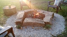 an outdoor fire pit with chairs around it