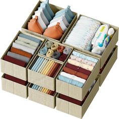 an organized drawer with folded cloths, diapers and other items in it on a white background