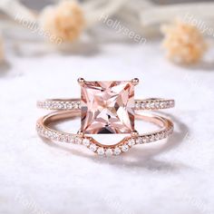 an engagement ring with a pink morganite surrounded by diamonds