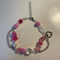 A handmade bracelet inspired by Barbie. Made with glass beads and wire, has a cute heart charm and is adjustable! Trendy Heart Shaped Beaded Charm Bracelet, Cute Charm Bracelet With Heart Beads, Trendy Heart Beads Bracelets For Jewelry Making, Barbie Bracelet, Bracelet Inspired, Valentine Ideas, Cute Heart, Wire Bracelet, Pink Bracelet