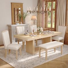 a dining room table with white chairs and a chandelier