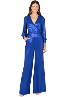 Spectacular shimmering jumpsuit in a stretch knit jersey fabric that fits like a glove. Features long sleeves and flowing pant legs with a v-neckline.   Back zip Metallic Jersey Jumpsuit Professionally clean Imported Designed for a wedding guest, gala party or a wedding event. Fits true to size Bra friendly Sheath fit friendly to your hips Model is 5'9 wearing a size 4 Formal Long Sleeve Jumpsuits And Rompers For Party Season, Spring Evening Long Sleeve Jumpsuits And Rompers, Evening V-neck Jumpsuits And Rompers For Fall, Glamorous Long Sleeve Jumpsuits And Rompers For Workwear, Evening Long Sleeve Jumpsuits And Rompers For Spring, Metallic Long Sleeve Jumpsuits And Rompers For Night Out, Metallic Long Sleeve Jumpsuits And Rompers For Party, Metallic Long Sleeve Jumpsuits For Night Out, Metallic Fitted Long Sleeve Jumpsuits And Rompers