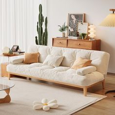 a living room with a white couch and wooden coffee table