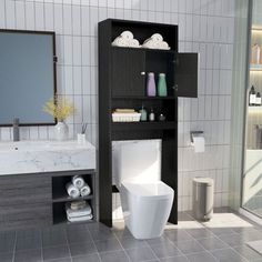 a white toilet sitting next to a sink in a bathroom