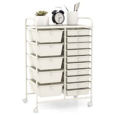 a white storage cart with many drawers and a clock on top