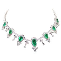 A Rare 18KT White Gold Emerald Diamond Necklace. Necklace is comprised of Finely Set Glittering Gorgeous Pear Shaped Emeralds and adorned with Sparkling Rose Cut and White Diamonds!! T.C.W. approx 43CTS!!! This Gorgeous Necklace is a Sample Piece from a Private Manufacturer that sold to Important 5 Star Hotel and Fine Jewelry Stores. Comes NWT: $205,000.00 and comes with a Certificate from the Gemological Appraisal Laboratory of America. A Magnificent Breathtaking Masterpiece!!! Luxury Emerald Necklace With Jewels For Formal Events, Luxury Emerald Necklace With Jewels For Formal Occasions, Luxury Emerald Necklace For Formal Events, Dazzling Jeweled Emerald Necklace For Formal Events, Luxury Hand Set Emerald Necklace For Parties, Formal Emerald Necklace With Diamond And Sparkling Stones, Fine Jewelry Diamond Necklace With Rhinestones For Formal Occasions, Luxury Rhinestone Necklaces For Formal Occasions, Emerald Diamond Necklace