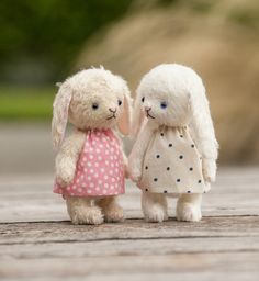 two small stuffed animals standing next to each other