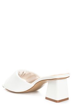 Slip into style with this heeled mule sandal that is perfect for any occasion. 2" heel Open toe Slip-on style Vegan leather upper/synthetic sole Imported Chic Low Heel Slip-on Sandals, Chic Slip-on Sandals With Low Heel, Chic Slip-on Block Heels With Padded Heel, Slip-on Block Heel Mules With Padded Heel, Spring Mules With Wooden Heel And Slip-on Fit, White Slip-on Synthetic Heels, White Mules With Heel Loop For Spring, Chic Slip-on Block Heels, Spring Synthetic Mules With Sculpted Heel