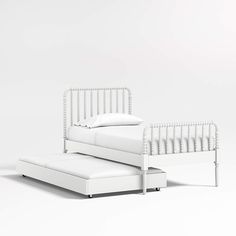 a white bed sitting next to a foot board