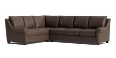 a brown leather sectional sofa sitting on top of a white floor