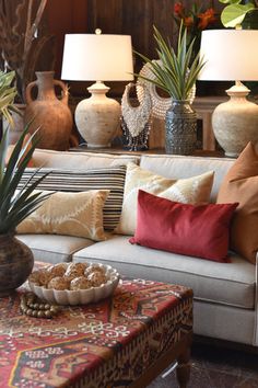 a living room filled with lots of furniture and vases