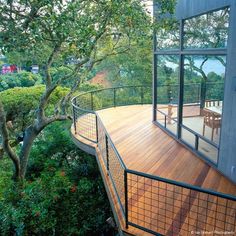 the deck is surrounded by trees and bushes