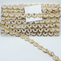 a white and gold beaded purse on display