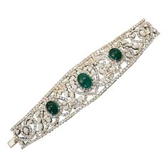 Diamond and Emerald Bracelet in 18k White Gold Features Three Cabochon Emeralds weighing a total of 20.00 carats estimated set with Round Brilliant Diamonds in Heart and Paisley design 30.00 carats in total of Diamonds Total Stone weight is 50.00 carats estimated Bracelet measures 7 inches long and 1.60 inches wide and weighs 101.4 grams Marked Chaar, 750 BUY WITH CONFIDENCE Authenticity is guaranteed for every item we sell. Luxury Cabochon Bangle Jewelry, Luxury Diamond Jewelry With Cabochon Cut, Luxury Cabochon Diamond Jewelry, Elegant Cabochon Bracelets For Anniversary, Formal Cabochon Bracelet Jewelry, Elegant Cabochon Bangle Jewelry, Luxury Wedding Bracelet With Cabochon, Luxury Cabochon Bracelets For Wedding, Elegant Cabochon Bracelet Jewelry