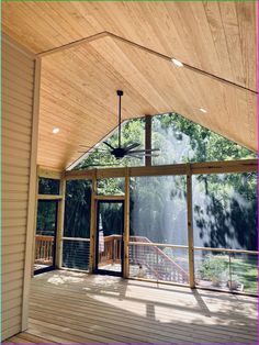 the inside of a house with wood flooring and ceiling fan on top of it