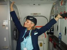 a woman in an airplane with her arms up