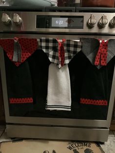 an oven with three ties hanging from it's front and two on the back