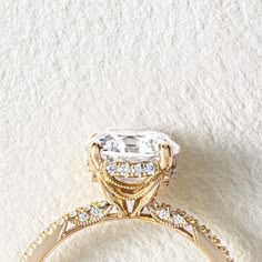 an engagement ring with a large diamond surrounded by smaller diamonds