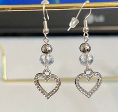 8mm high quality clear crystal glass faceted beaded earrings with silver plated beads and rhinestone hearts. Earrings have silver plated hooks with rubber stoppers. Comes in a gift box ready for gift giving. Silver Crystal Beaded Earrings For Gift, Rhinestone Earrings Diy, Crystal Heart Dangle Earrings For Gift, Silver Crystal Heart Earrings, Crystal Heart Earrings With Rhinestones, Diy Rhinestone Earrings, Silver Heart-shaped Crystal Earrings, Hearts Earrings, Earrings Hanging