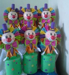 several clowns made out of toilet paper are sitting on top of a towel rack