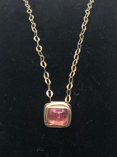 Nothing is as luxurious as solid gold! This 14 karat gold pendant is set with one of my favorite gemstones, a tourmaline cabochon--seriously, they look like candy. The color is pink with a hint of peach which is enhanced by the gold setting. The 18 inch chain and handmade clasp are solid 14 karat gold. 14 karat gold is hypoallergenic and durable enough for everyday wear. For discounts on the same items listed in my Etsy shop, check out idlegauds.com. Formal Yellow Gold Tourmaline Jewelry, Formal Yellow Gold Tourmaline Necklaces, Formal Yellow Gold Tourmaline Necklace, Formal Gold Jewelry With Tourmaline, Formal Gold Tourmaline Jewelry, Pink Gemstone Necklace In 14k Gold, Pink 14k Gold Jewelry With Polished Finish, Modern Pink Jewelry With Polished Finish, Pink Cabochon Jewelry For Formal Occasions