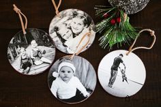 three ornaments are hanging on a wooden table