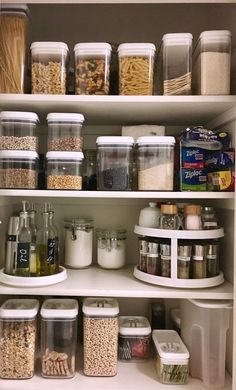 an organized pantry filled with lots of food and storage containers on top of white shelves