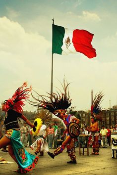 some people are dancing around with flags in the background