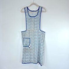 a blue and white dress hanging on a wall