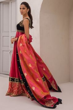 Add depth and femininity to your festive wardrobe with this panelled cranberry coloured khaddi silk two-tone peshwas with an attached velvet bodice. The brocade stole is finished with velvet and printed borders. Red Tissue Silk Kurta With Traditional Drape, Red Chanderi Lehenga With Dabka Detailing, Red Anarkali Tissue Silk Kurta, Red Silk Dupatta With Dabka, Red Anarkali Kurta In Tissue Silk, Red Tissue Silk Kurta With Dabka Work, Red Tissue Silk Anarkali Set For Eid, Red Raw Silk Dupatta With Dabka Detail, Red Raw Silk Dupatta With Dabka