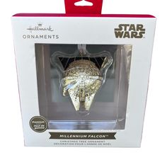 the millennium falcon ornament is packaged in a box with its packaging on it