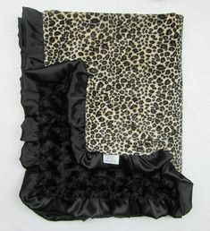 two pieces of animal print with black ruffles