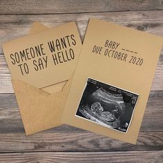 two brown envelopes with black ink on them and an image of a baby in the belly