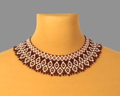 a brown and white beaded necklace on a mannequin neckline with beads