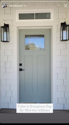 the front door is painted white and has two lanterns on it, along with a window that reads color is evergreen fog by sheryln williams