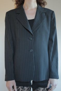 Best of 1990's classic minimalist cool Emporio Armani two button blazer. Great androgynous masculine style. Pin stripes on black background with white and grey stripes. Side front pockets. Fully lined. Slight shoulder pads give good shape to the shoulders. Label Emporio Armani, Made in Italy, Size 46. Dry clean only. 61% rayon, 30% pure wool, 5% nylon, 3% cotton, 1% polyester. Lining 100% rayon. Very good vintage condition with no fabric or sewing flaws. MeasurementsShoulders 44cm/ Chest 102cm/ Business Blazer With Vertical Stripes And Long Sleeves, Office Blazer With Vertical Stripes And Long Sleeves, Fitted Blazer With Vertical Stripes And Long Sleeves, Fitted Long Sleeve Blazer With Vertical Stripes, Classic Striped Blazer For Office, Tailored Striped Outerwear For Office, Winter Striped Blazer For Business Casual, Classic Striped Outerwear For Office Wear, Pinstripe Blazer For Office Wear In Fall