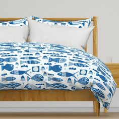 a bed with blue and white fish on it