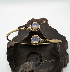 HANDMADE  Beautiful Boho, hippie handcrafted arm cuff bracelet with detailed and Beautiful gemstones  This piece has some beautiful work  Handmade with high quality hypoallergenic Jewelery brass, nickel free. Adjustable, it will fit any size. Aprox diameter round gemstone piece: 1.3 cm LINK Don't miss the rest of the collection, please follow the link.  https://www.etsy.com/uk/shop/JagathaStudio Handmade Bohemian Bangle As Gift, Artisan Bangle Jewelry For Festivals, Adjustable Hand Wrapped Hippie Jewelry, Hand Wrapped Adjustable Hippie Jewelry, Unique Adjustable Wrap Bangle Bracelet, Adjustable Hippie Hand Wrapped Jewelry, Adjustable Wrap Bracelet For Festivals, Nickel-free Bohemian Bangle Cuff Bracelet, Adjustable Unique Wrap Bangle Bracelet