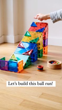 a child is playing with some colorful blocks