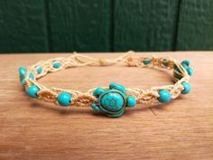 "High quality synthetic Turquoise macrame Turtle anklet. Waterproof waxed string anklet with Blue  Turtle beads. Hand knotted surfer anklet, super durable beach jewelry! Beige macrame ankle bracelet with 6mm synthetic Turquoise and Turtle beads. (other colors available at checkout)  Also available as a choker necklace at checkout. One size fits all! 1/4 inch width for an elegant style. Looks great combined with other ankle bracelets for a cool layered effect  The color of the beads may vary slightly depending on the device you are viewing with.    Woven with top quality waxed polyester Linhasita string from Brazil, it's waterproof and fade resistant.  The adjustable slip knot closing system makes it easy to take on and off and assures a comfortable and secure fit. Made with love   :) * PLE Hippie Turquoise Friendship Bracelets For Beach, Turquoise Macrame Bracelet For Beach, Turquoise Macrame Bracelets For Beach, Hippie Style Waxed Cord Jewelry For Beach, Handmade Turquoise Braided Bracelets For Beach, Hippie Braided Bracelets For Beach With Sliding Knot, Handmade Turquoise Braided Bracelet For Beach, Hippie Braided Bracelet For Beach With Sliding Knot, Hippie Braided Bracelets With Sliding Knot For Beach