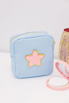 This little cosmetic bag is perfect for the girl on the go! It's such a good size to hold all of your smaller items that could get lost in a larger bag. We love this size cosmetic bag for things like contacts cases, lip balms, hair ties and bobby pins. We also love that this cutie can be personalized to be all your own! Patch placements are as pictured. We are unable to accommodate copyrighted phrases/abbreviations/initials. Personalized items are final sale. Blue Travel Cosmetic Bag With Removable Pouch, Blue Cosmetic Bag With Removable Pouch For Everyday Use, Blue Cosmetic Bag With Removable Pouch, Cute Portable Cosmetic Bag For Travel, Blue Travel Pouch With Removable Section, Cute Portable Blue Bag, Blue Zipper Pouch Cosmetic Bag For Everyday Use, Light Blue Zipper Pouch Bag For Travel, Light Blue Travel Bag With Zipper Pouch