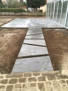 a concrete walkway in front of a house