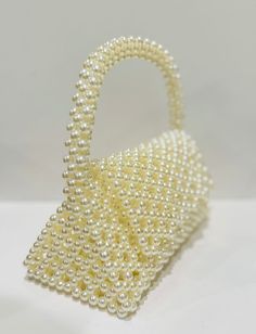 beautiful white pearl purse to elevate your style. fits your phone White Pearl Evening Bag For Party, Pearl White Beaded Evening Bag For Party, Cream Party Clutch Shoulder Bag, Cream Clutch Shoulder Bag For Party, Elegant Handheld Beaded Evening Bag, White Evening Bag With Pearl Handle For Party, Luxury Pearl Evening Bag As Gift, Beaded Pearl Evening Bag, White Evening Bag With Pearl Embroidery For Party