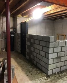 an unfinished basement with concrete blocks stacked on top of each other in preparation to be installed