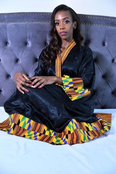 This Kente and black silk kimono robe is crafted to give homage to Africa's cultural heritage and rich traditions. The Kente Ankara vibrant print is paired with modern black silk fabric, creating an opulent and sophisticated effect. It is luxuriously #handfinished for the bold and beautiful woman. CUSTOM MADE TO FLATTER YOUR CURVES. COMFY CHIC. Click to Shop! #kenteprint #africanfashion #pinterestfashion #giftideas #timelessfashion #blacksilkrobe #blacklingeriegown #plussizelingerie #silkrobes Traditional Black Ceremonial Dress, Traditional Long Black Kaftan, Elegant Black Kaftan For Festivals, Black Kaftan For Festivals, Traditional Black Kaftan For Ceremonies, Black Silk Dress With Kimono Sleeves, Black Long Sleeve Dress For Traditional Ceremonies, Traditional Black Dress With Kimono Sleeves, Black Silk Long Sleeve Robe