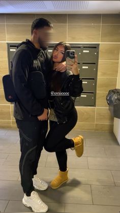 a man and woman taking a selfie in the bathroom