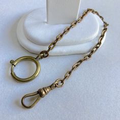 "Up for sale is this vintage estate 7-3/4\" bronze shade gold filled German pocket watch chain bracelet, etched links with dog clip clasp, Ca 1930s-1940s.  This German pocket watch chain comes in a beautiful bronze shade with etched links and measures 7-3/4\" long.  The round spring clip is marked GERMANY.  The piece weighs 5.0 grams.  Note that some photos are enlarged to show details. Condition:  This pocket watch chain is pre-owned and vintage and as such, expect wear... surface wear, aging d Antique Chain Bracelet For Formal Occasions, Vintage Oval Link Chain Bracelet, Vintage Yellow Gold Brass Chain Bracelet, Pocket Watch Chain, Dog Clip, Gold Box, Pocket Watches, Watch Chain, Box Chain